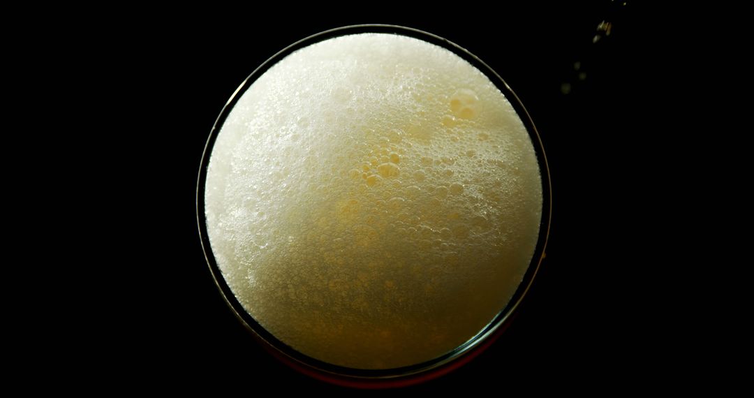 Top view of beer foam and bubbles on black background - Free Images, Stock Photos and Pictures on Pikwizard.com