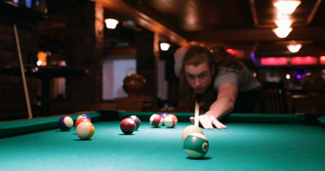 Focused Man Taking Shot at Pool Hall Table - Free Images, Stock Photos and Pictures on Pikwizard.com