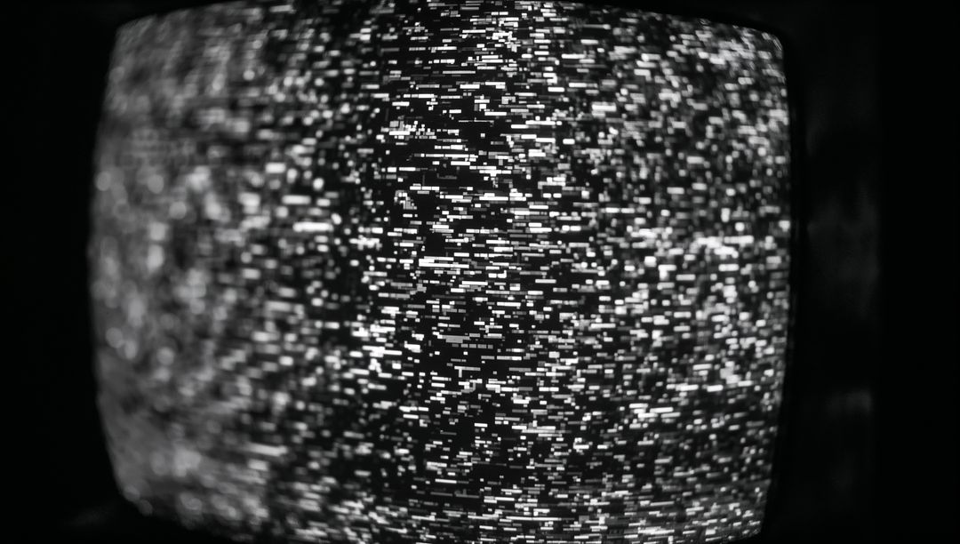 Black and White TV Static on Curved Screen in Dim Room