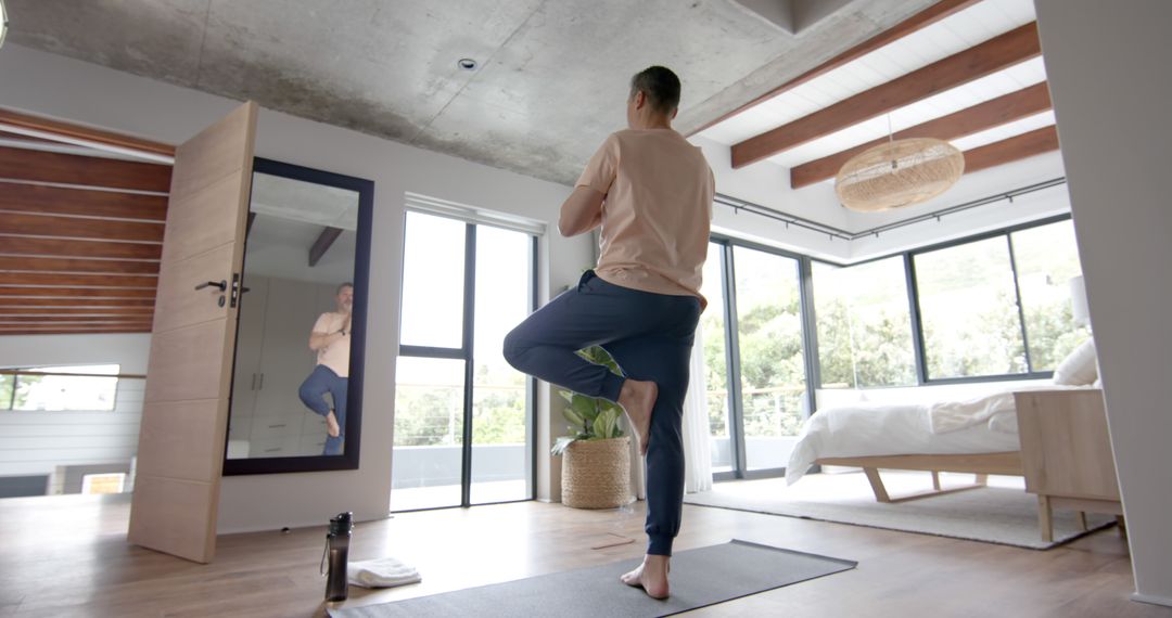 Man Practicing Yoga at Home in Spacious Modern Bedroom - Free Images, Stock Photos and Pictures on Pikwizard.com