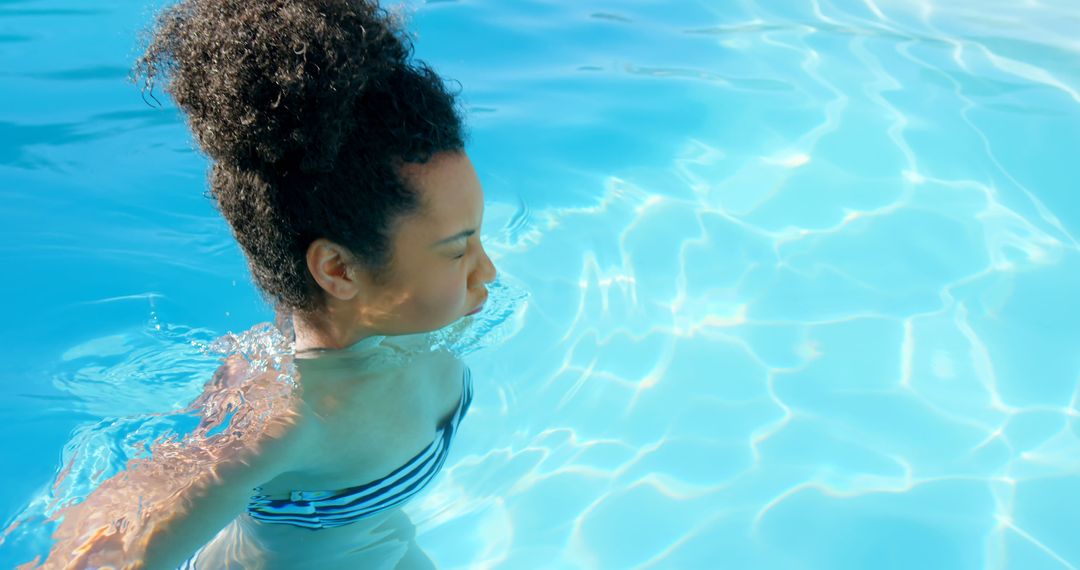 Woman Swimming in Clear Blue Pool Water - Free Images, Stock Photos and Pictures on Pikwizard.com