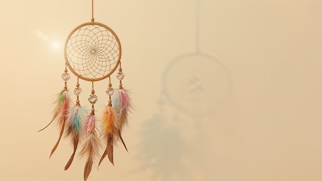 Dreamcatcher With Feathers Casting Shadow on Beige Wall