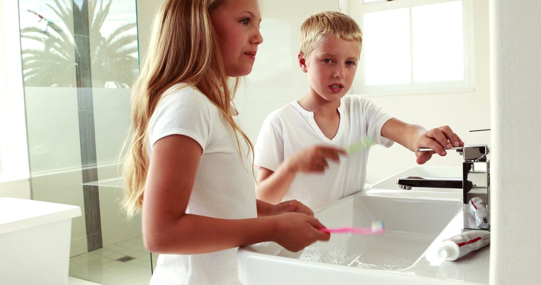 Children Brushing Teeth Together in Modern Bathroom - Free Images, Stock Photos and Pictures on Pikwizard.com