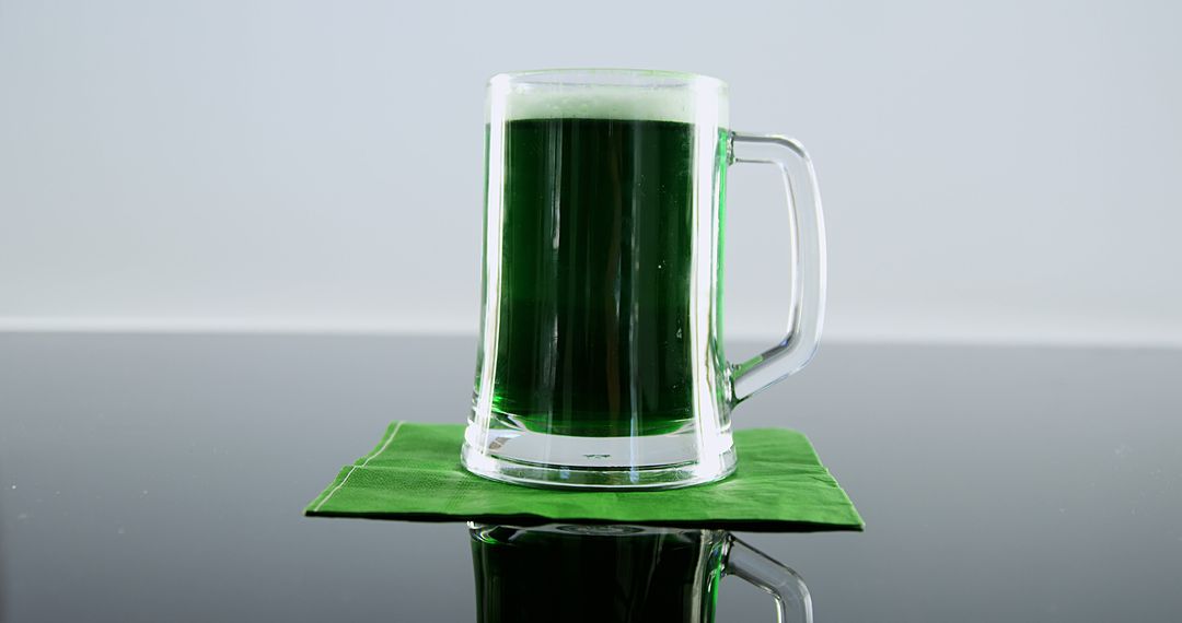 Glass of Green Beer on Reflective Surface - Free Images, Stock Photos and Pictures on Pikwizard.com