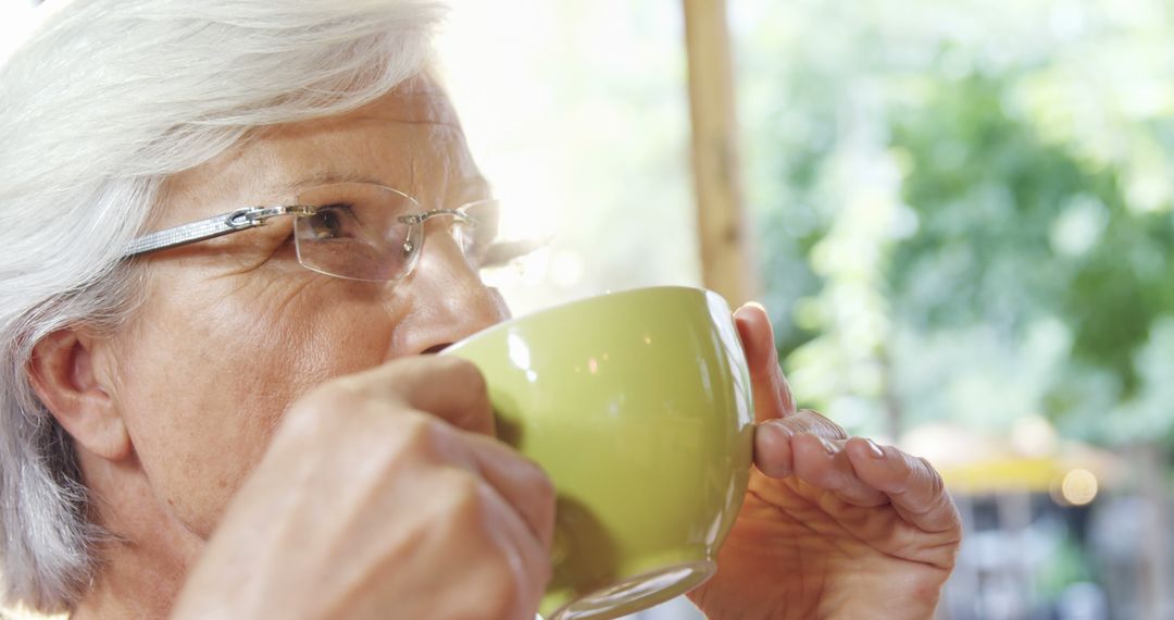 Senior Woman Enjoying Hot Beverage in Outdoor Cafe - Free Images, Stock Photos and Pictures on Pikwizard.com