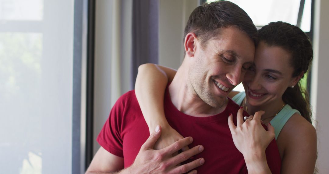 Happy Caucasian Couple Relaxing by Window at Home