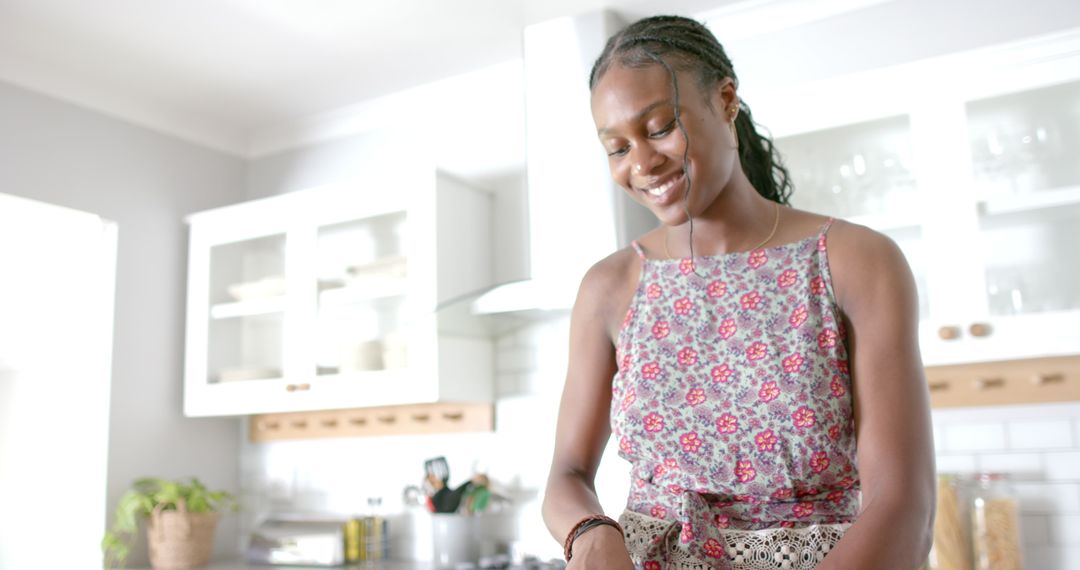 Joyful African American Woman Preparing Meal in Modern Kitchen