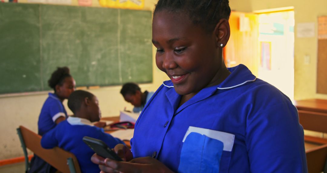 African Schoolgirl Texting on Smartphone in Classroom - Free Images, Stock Photos and Pictures on Pikwizard.com