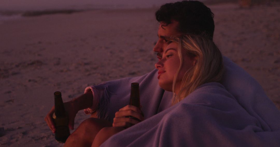 Couple Enjoying Sunset on Beach Together with Drinks - Free Images, Stock Photos and Pictures on Pikwizard.com