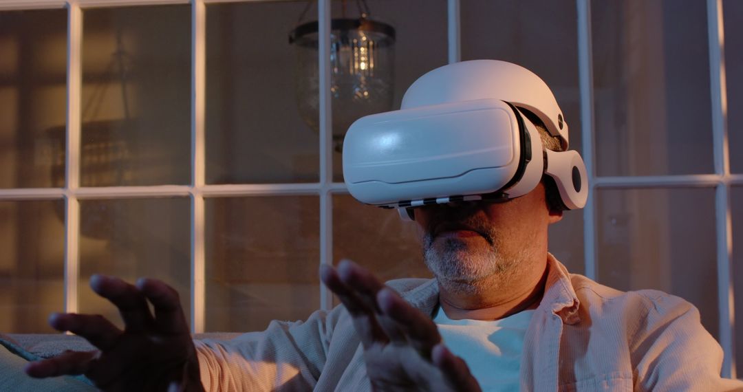 Senior Man Immersed in Virtual Reality Experience at Home