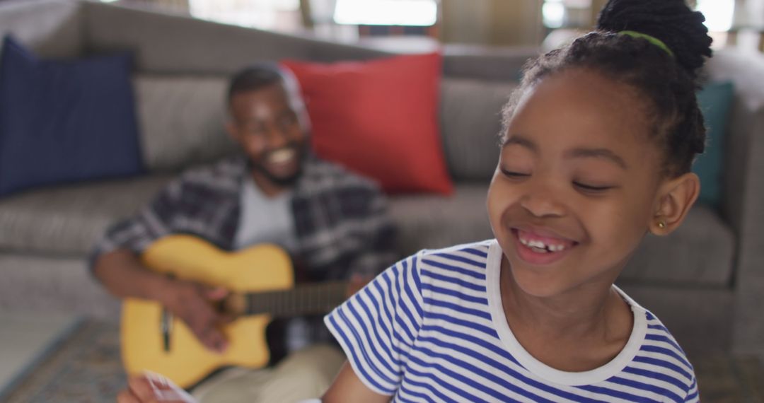 Happy Family: Daughter Dancing, Father Playing Guitar