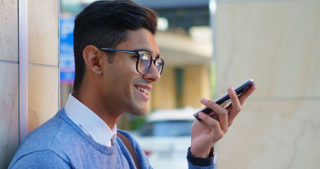 Smiling Man with Glasses Speaking on Smartphone Outdoors - Free Images, Stock Photos and Pictures on Pikwizard.com