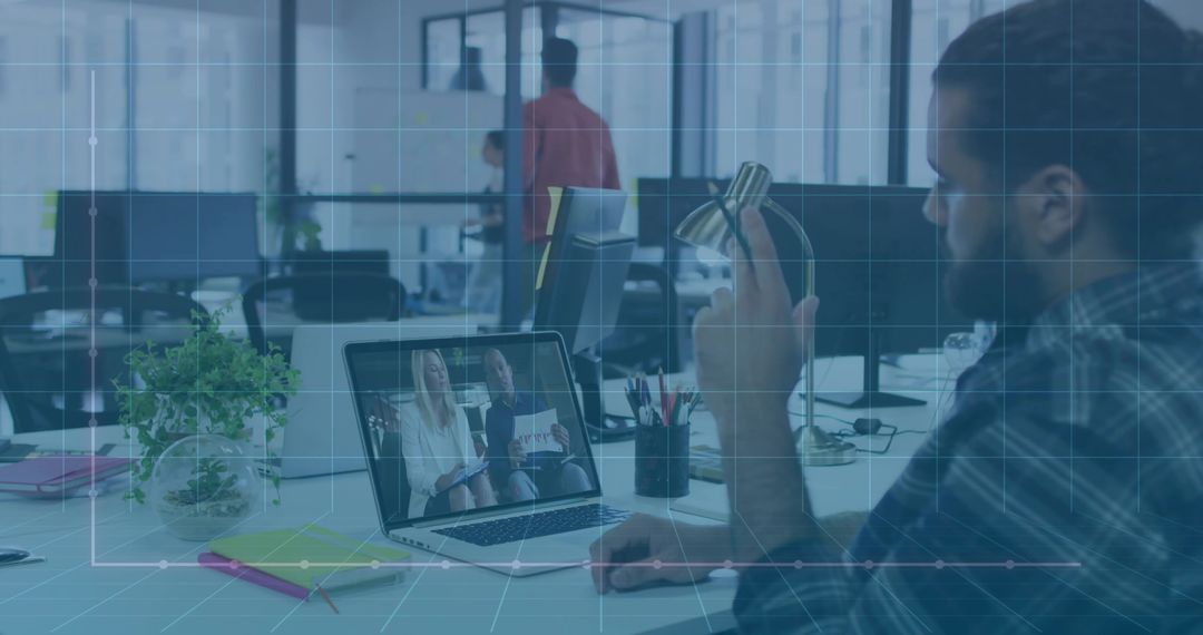 Man Engaging in Video Conference Call with Colleagues in Office