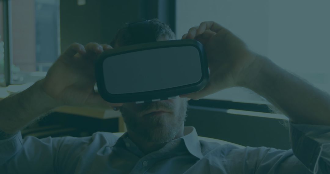 Middle-Aged Man Using VR Headset in Modern Office Environment