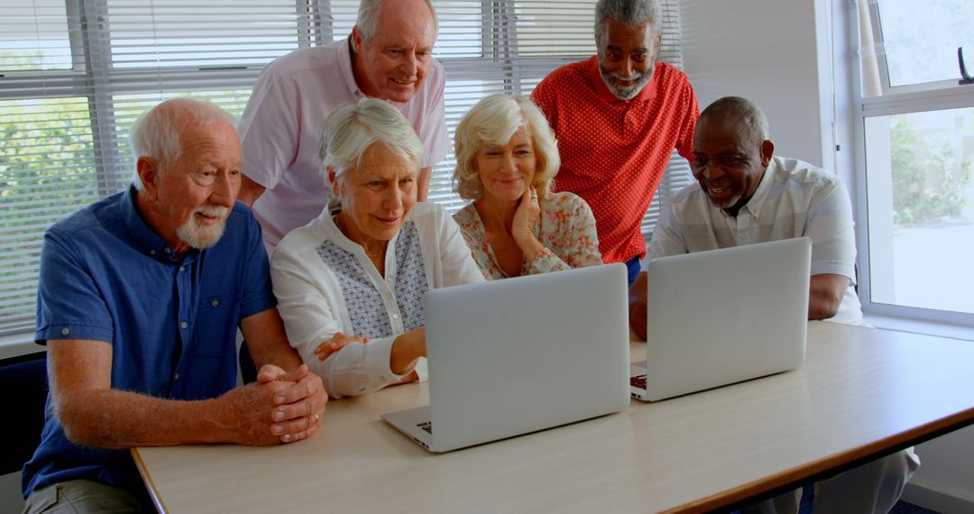 Diverse Senior Friends Engaged with Laptops in a Group Setting