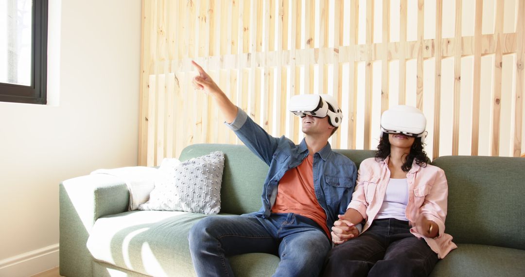 Couple Experiencing Virtual Reality Together on Sofa