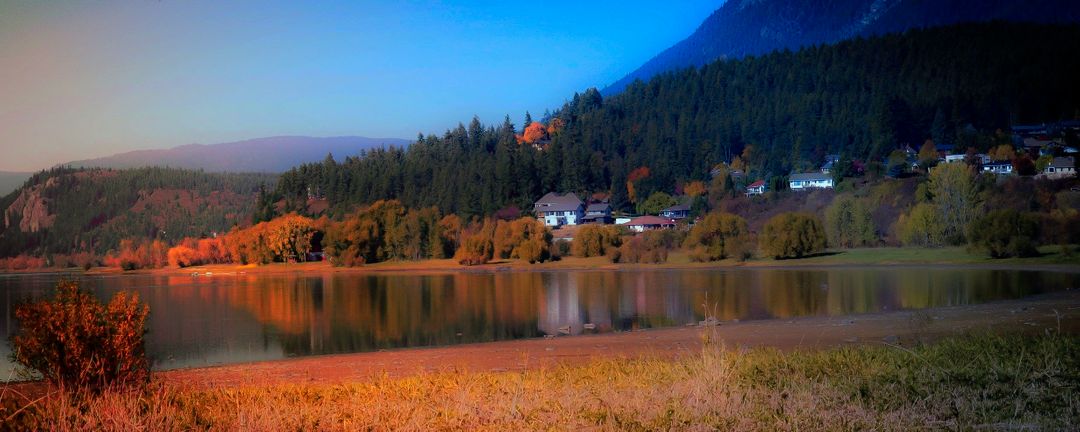 Scenic Autumn Landscape with Lakeside Village and Mountain View - Free Images, Stock Photos and Pictures on Pikwizard.com