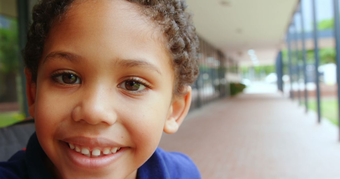 Happy Boy on Wheelchair Smiling in School Corridor