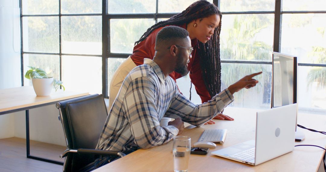 Two Colleagues Engaged in Team Discussion at Office