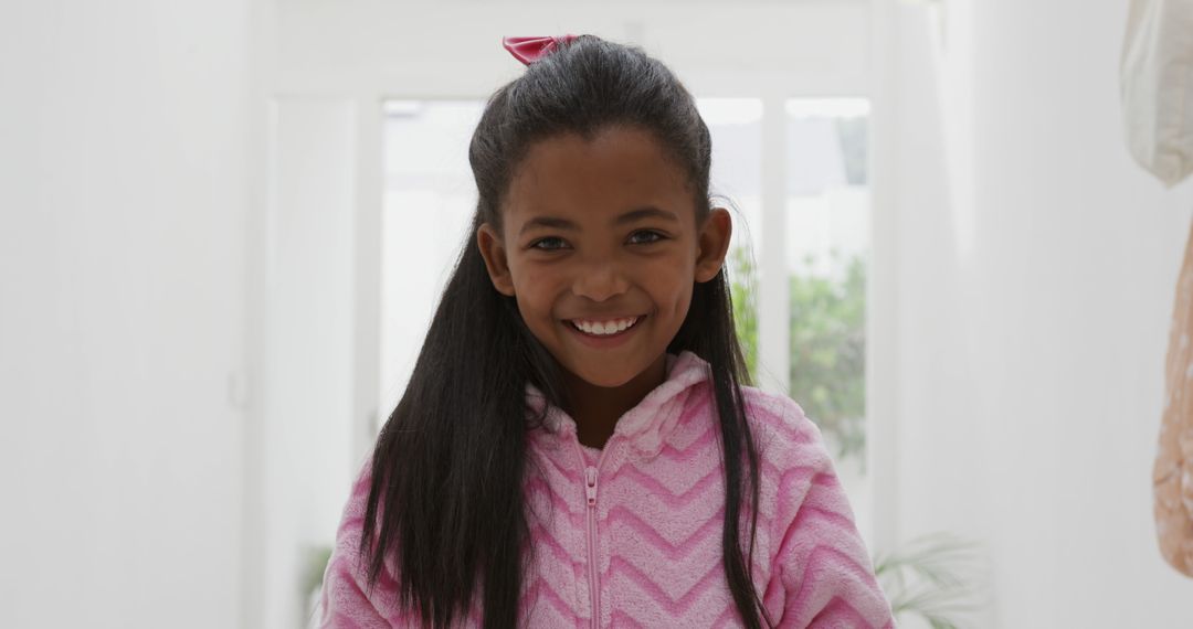 Smiling Girl in Pink Sweater with Long Hair Indoors - Free Images, Stock Photos and Pictures on Pikwizard.com