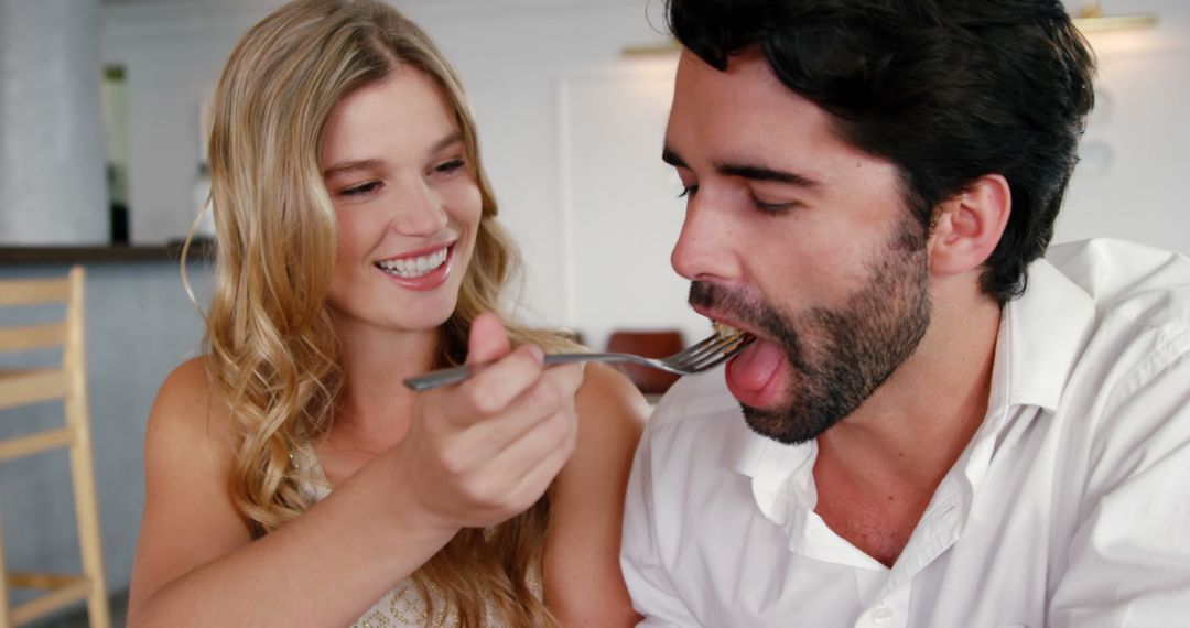 Happy Couple Sharing Meal in a Café Setting