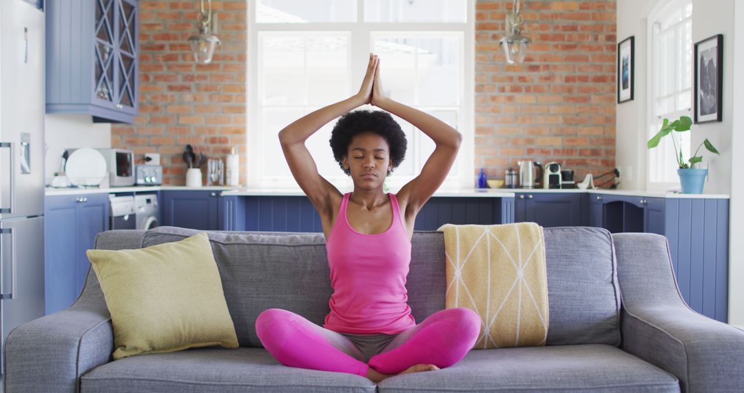 Woman Meditating on Couch in Living Room - Free Images, Stock Photos and Pictures on Pikwizard.com