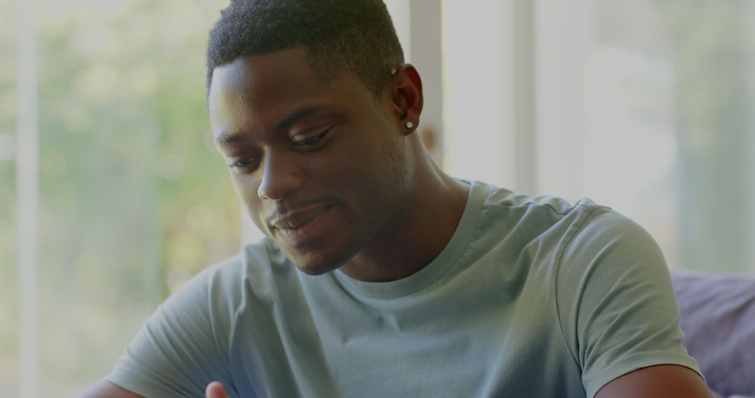 Man Relaxing Indoors Enjoying Smartphone Leisure Time
