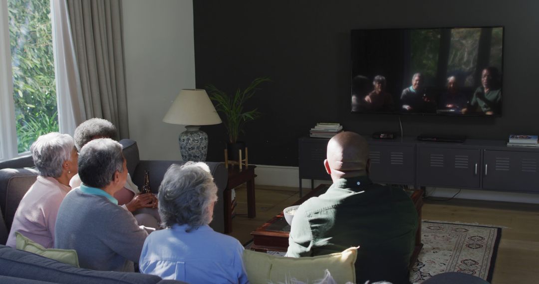 Group of Seniors Watching Television Together in Living Room - Free Images, Stock Photos and Pictures on Pikwizard.com