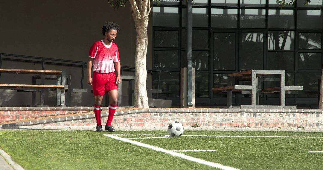 Young Soccer Player Practicing on School Field