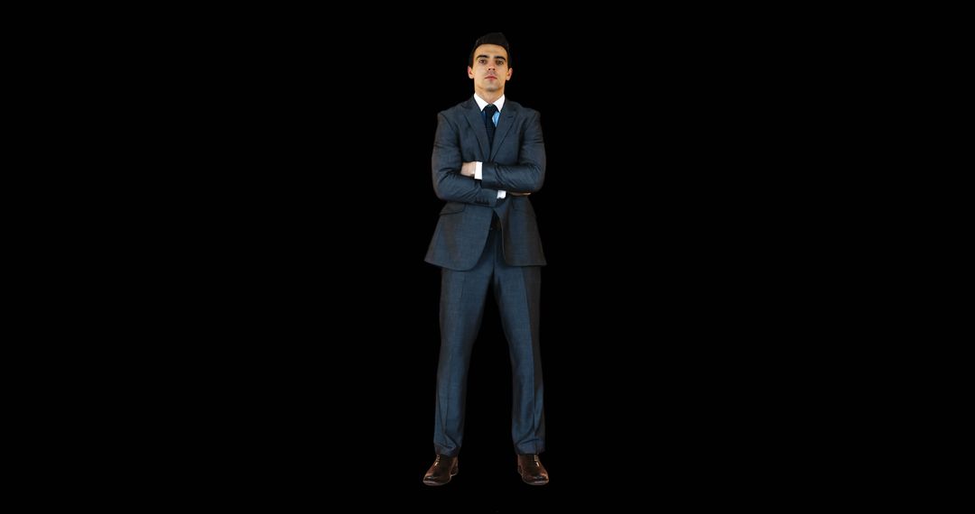 Young businessman standing with arms crossed against black background - Free Images, Stock Photos and Pictures on Pikwizard.com