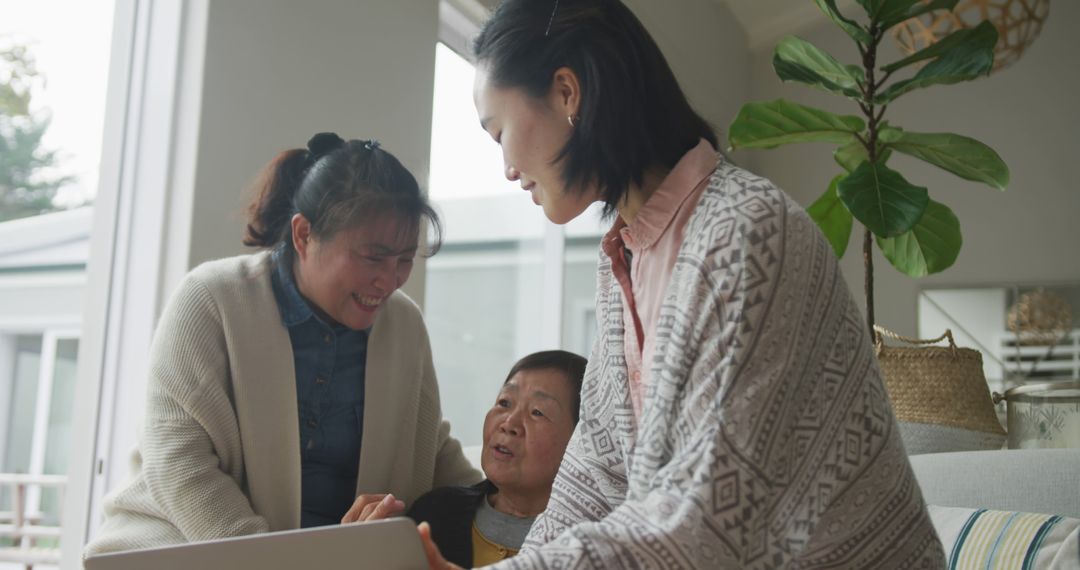 Multi-Generational Asian Family Bonding with Laptop Technology