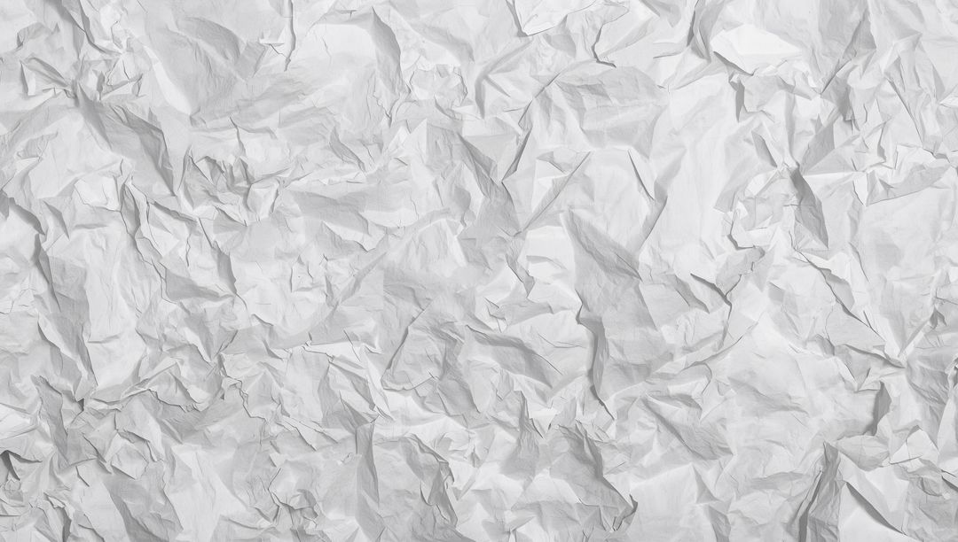 Crumpled White Paper Texture Background Showing High-Contrast Folds and Soft Shadows