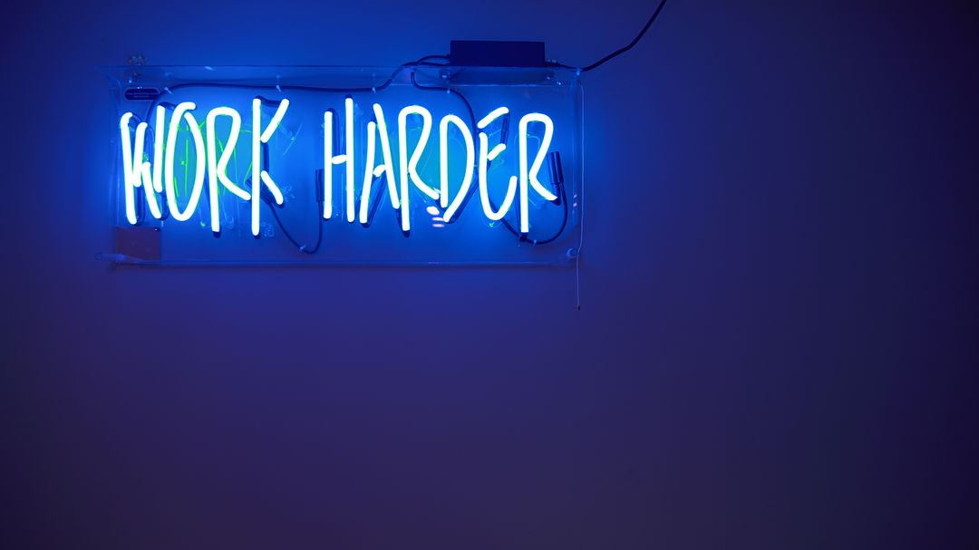Neon Work Harder Sign in Dark Room - Free Images, Stock Photos and Pictures on Pikwizard.com