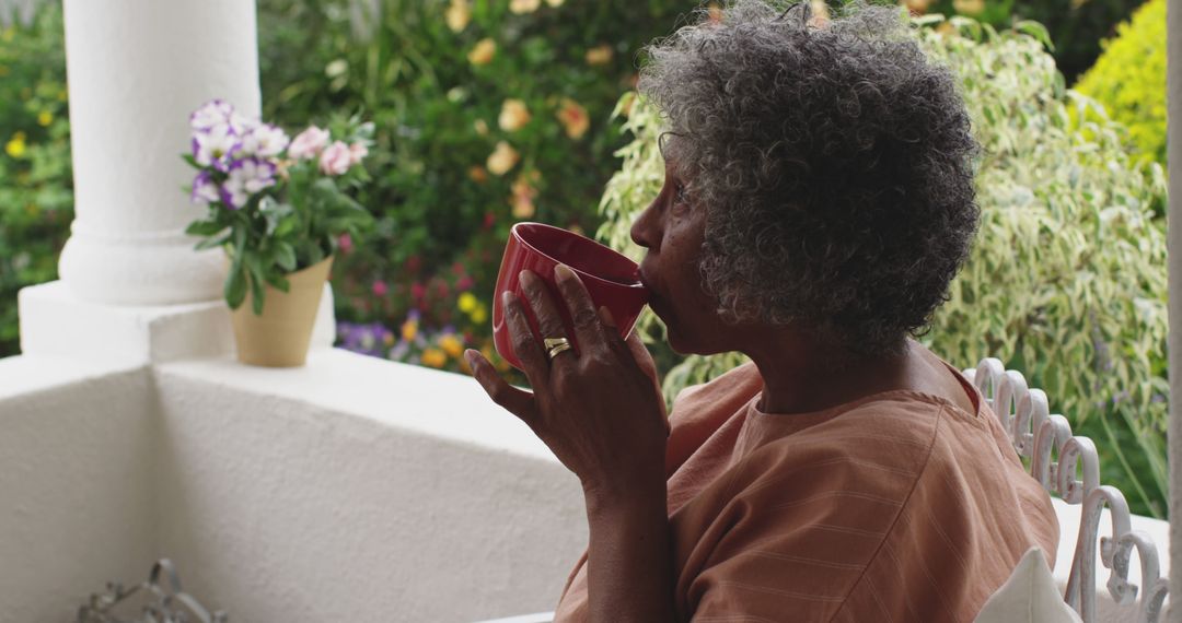 Relaxing African American Woman Drinking Coffee on Terrace - Free Images, Stock Photos and Pictures on Pikwizard.com