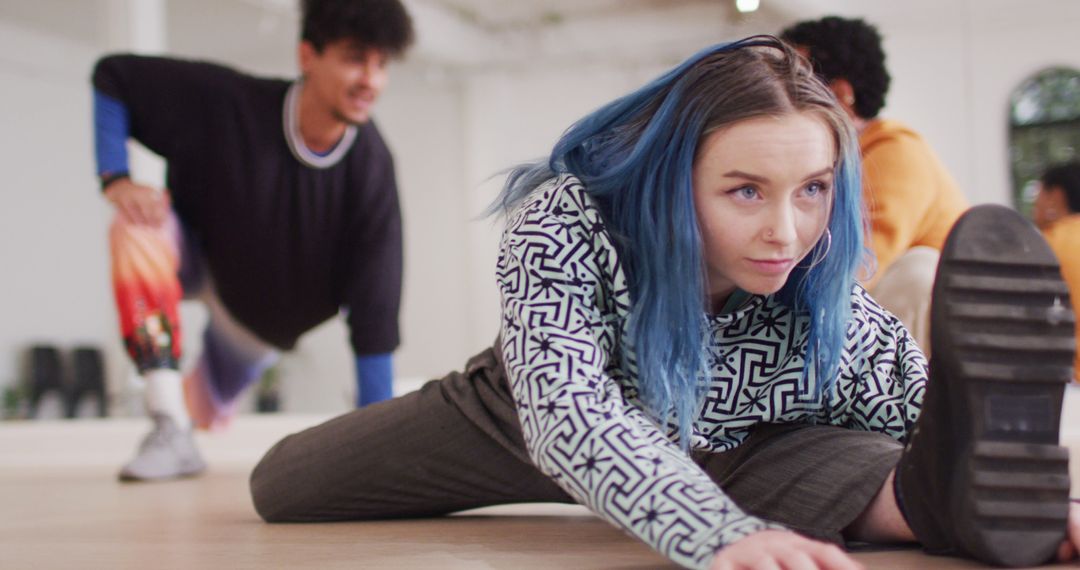 Young Woman with Blue Hair Stretching During Dance Practice - Free Images, Stock Photos and Pictures on Pikwizard.com