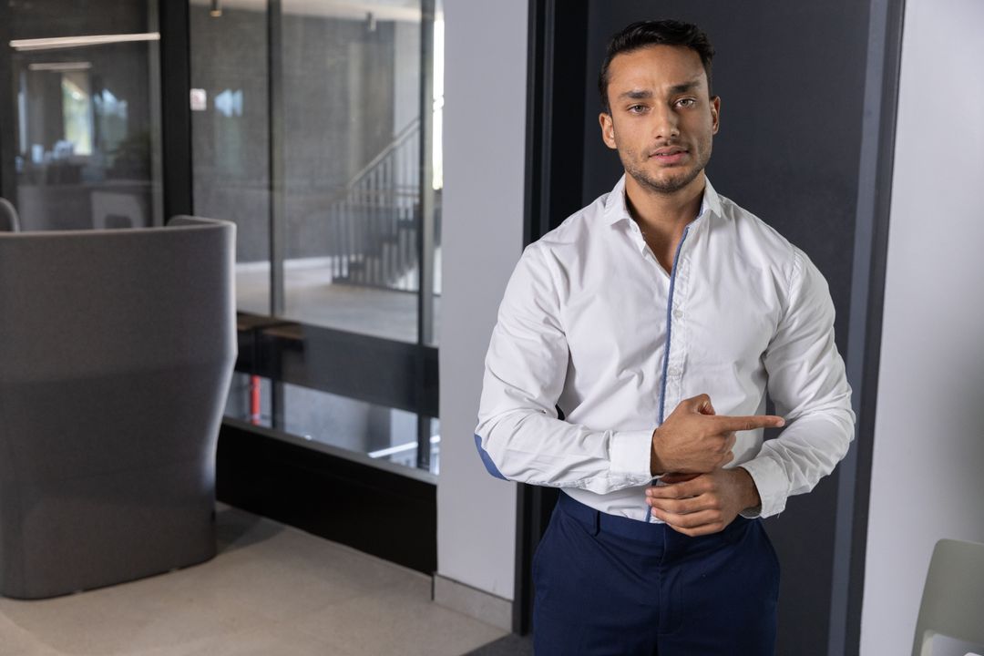 Professional Businessman Pointing Inside Modern Office Setting