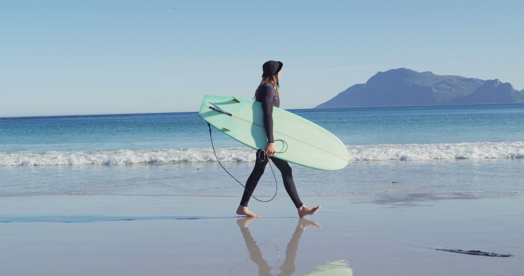 Surfer Walking on Peaceful Beach with Surfboard - Free Images, Stock Photos and Pictures on Pikwizard.com