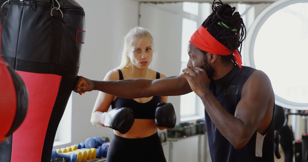 Personal Trainer Showing Female Client Boxing Techniques in Modern Gym - Free Images, Stock Photos and Pictures on Pikwizard.com