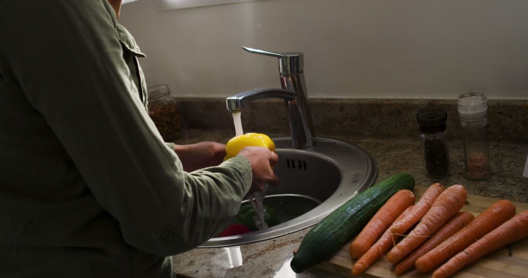 Image of midsection of biracial woman washing carrots - Free Images, Stock Photos and Pictures on Pikwizard.com