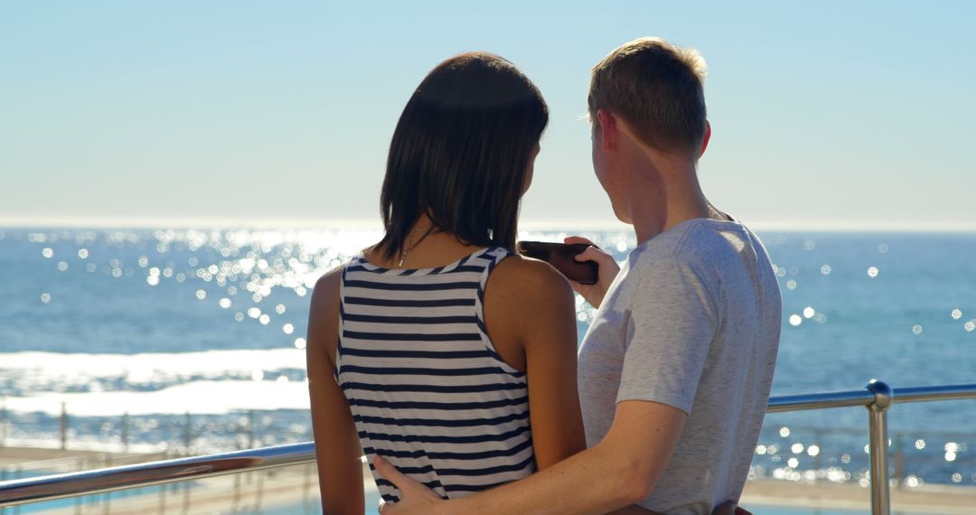 Couple Embracing and Taking Selfie with Ocean View - Free Images, Stock Photos and Pictures on Pikwizard.com