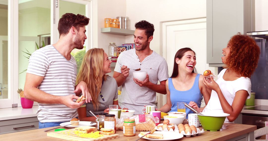 Group of Friends Laughing and Eating Breakfast in Modern Kitchen - Free Images, Stock Photos and Pictures on Pikwizard.com