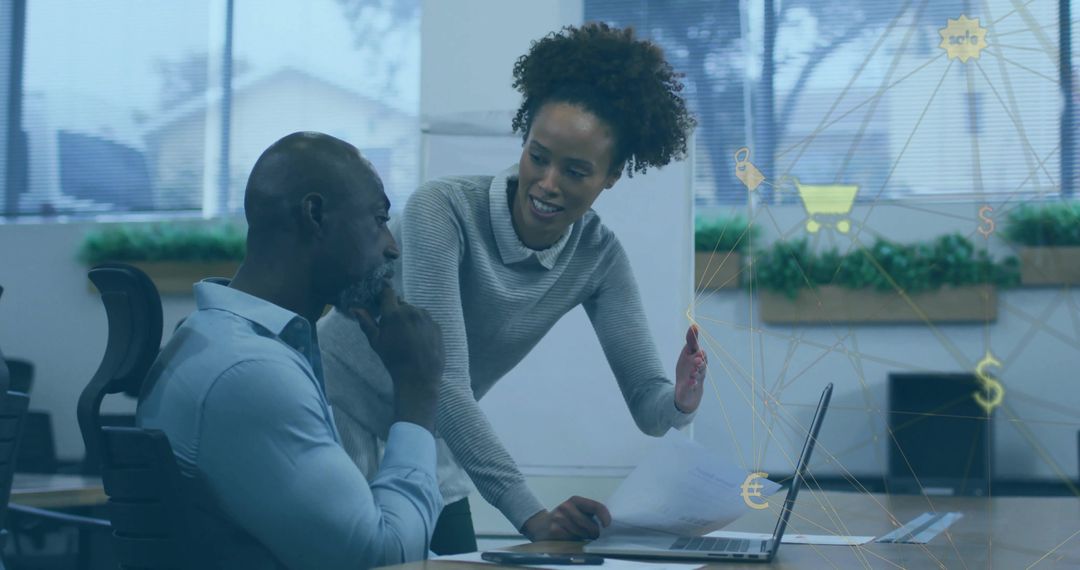 Colleagues Discussing Data Analysis in Modern Office Workspace