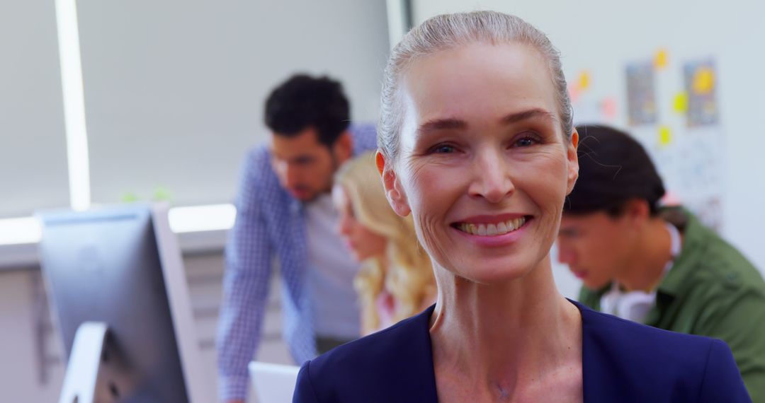 Confident Senior Businesswoman Smiling in Modern Office - Free Images, Stock Photos and Pictures on Pikwizard.com