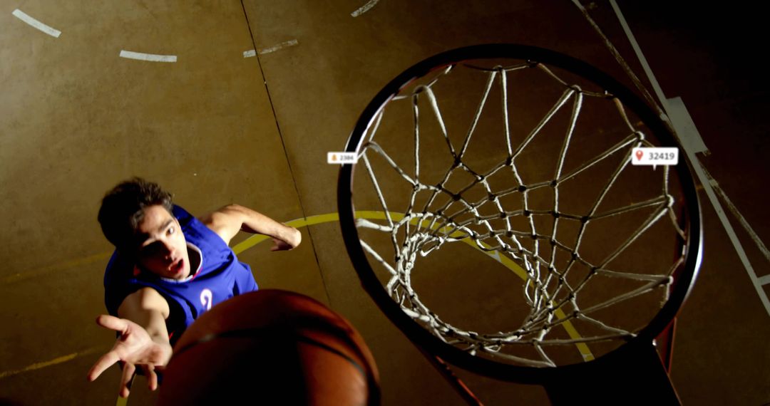 Overhead Basketball Action: Player Reaching for Ball Over Rim With Dramatic Lighting