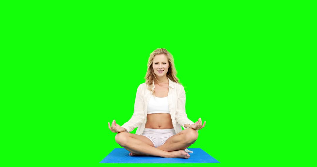 Woman Practicing Yoga Meditation on Blue Mat with Green Background - Free Images, Stock Photos and Pictures on Pikwizard.com