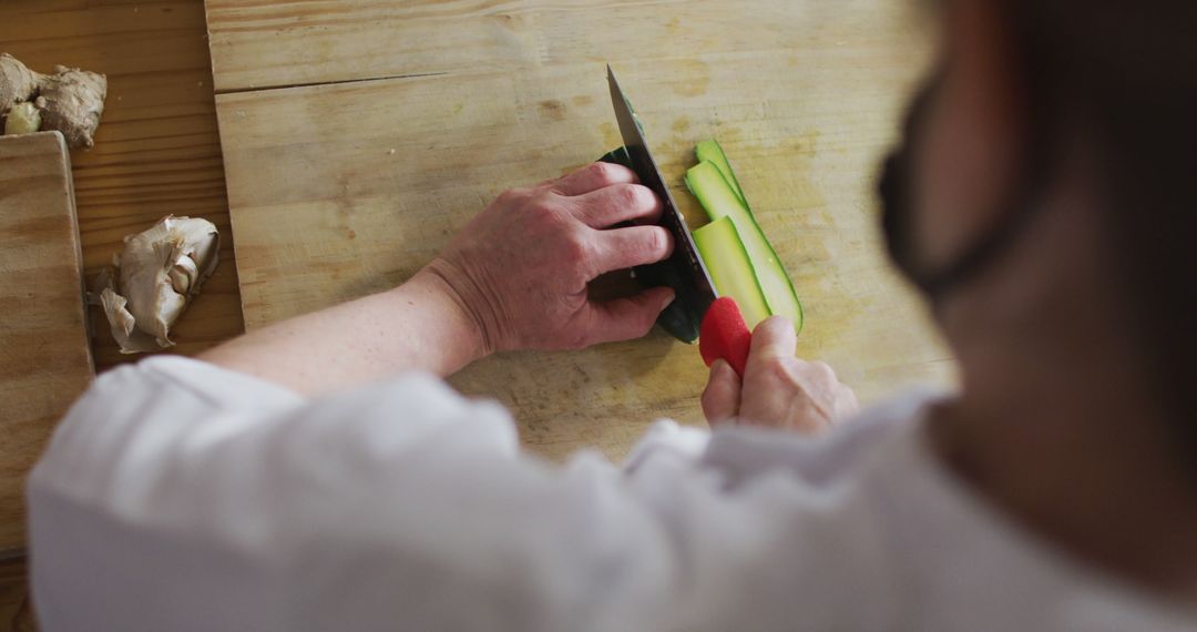 Chef Slicing Fresh Zucchini on Wooden Board in Professional Kitchen - Free Images, Stock Photos and Pictures on Pikwizard.com