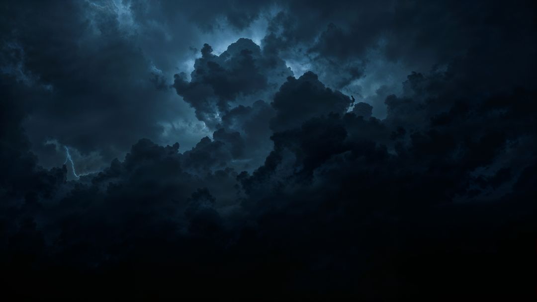 Dramatic storm clouds with negative energy lightning in night sky