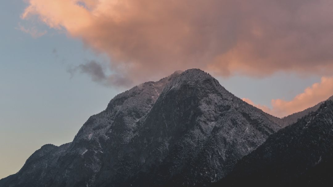 Snow-covered mountain peak at sunset with pink clouds - Free Images, Stock Photos and Pictures on Pikwizard.com