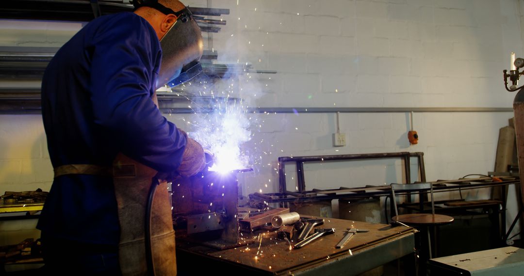 Metal Worker Welding In Workshop, Sparks Flying - Free Images, Stock Photos and Pictures on Pikwizard.com