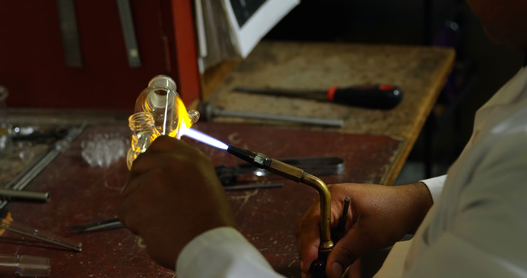 Glassblower Working on Intricate Piece with Blowtorch in Workshop - Free Images, Stock Photos and Pictures on Pikwizard.com